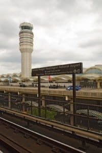 ARLINGTON VIRGINIA - JULY 21 2014: Washington DC metro sign and control tower for Ronald Reagan National airport. The airport has very tight security and is the main gateway into the US capital city.